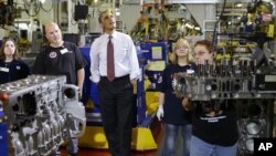 President Barack Obama watches workers during a visit to the heavy duty engines line at the Daimler Detroit Diesel plant in Redford, Michigan, Monday, Dec. 10, 2012.