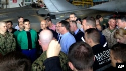 U.S. Secretary of Defense Ash Carter, center in blue shirt, speaks to U.S. and French troops on the French aircraft carrier Charles de Gaulle in the Persian Gulf, Dec. 19, 2015. 