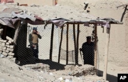 Policemen inspect an area after a bomb explosion near a polling station in Kabul, Afghanistan, Oct. 20, 2018.