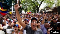 Anti-government protesters shout during a protest against Nicolas Maduro's government in Caracas, March 3, 2014.