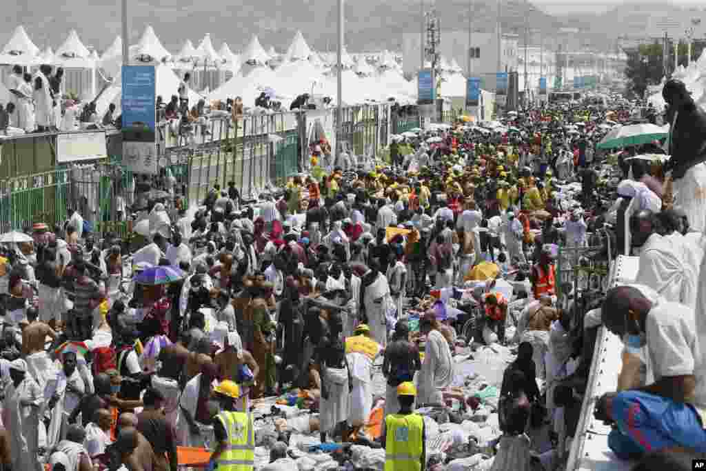 Muslim pilgrims and rescuers gather around the victims of a stampede in Mina, Saudi Arabia during the annual hajj pilgrimage. More than 700 pilgrims were killed and hundreds were injured​, Saudi authorities said.