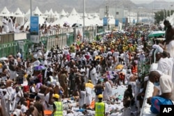 FILE - Muslim pilgrims and rescuers gather around the victims of a stampede in Mina, Saudi Arabia during the annual hajj pilgrimage, Sept. 24, 2015.