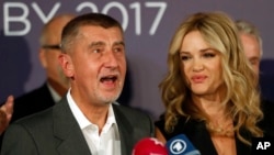Czech billionaire and leader of ANO 2011 political movement Andrej Babis accompanied with his wife, Monika, addresses the media after most of the votes were counted in the parliamentary elections in Prague, Czech Republic, Oct. 21, 2017. 
