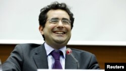 FILE - Executive director of UN Watch Hillel Neuer smiles after the presentation of a report by the Independent Commission of Inquiry on the 2014 Gaza Conflict in Geneva, June 29, 2015.