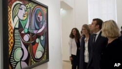 FILE - France's President Emmanuel Macron visits the "Picasso 1932: Erotic Year" exhibition at the Picasso museum in Paris, Oct. 8, 2017.