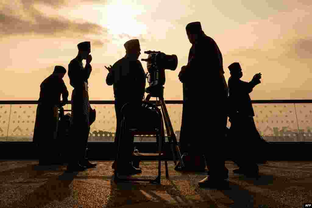 An official uses a telescope to perform &quot;rukyah&quot;, the sighting of the new moon for the Muslim holy fasting month of Ramadan, in Putrajaya, Malaysia.