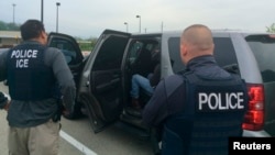 FILE - Officers from U.S. Immigration and Customs Enforcement's (ICE) are shown during an operation targeting criminal aliens and other immigration violators in Philadelphia, May 11, 2016.