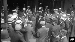 Jane Addams speaking to a crowd upon her arrival from the Netherlands after attending an international women's peace conference.