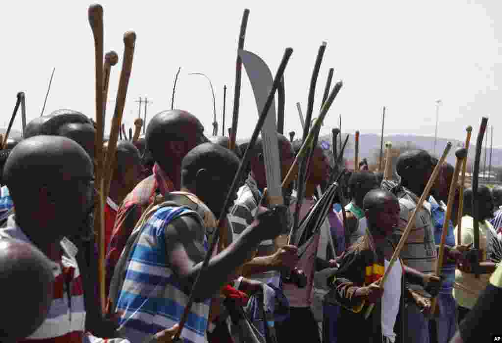 Striking mine workers armed with machetes, sticks, and spears march to a smelter plant at the Lonmin Platinum Mine near Rustenburg, South Africa, September, 12, 2012.