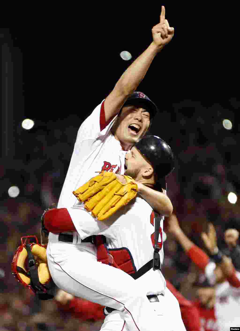 Oct 30, 2013; Boston, MA, USA; Boston Red Sox relief pitcher Koji Uehara (19) reacts with catcher David Ross (3) after defeating the St. Louis Cardinals in game six of the MLB baseball World Series at Fenway Park. Red Sox won 6-1. Mandatory Credit: Greg M