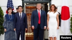 U.S. President Donald Trump and first lady Melania Trump welcome Japan's Prime Minister Shinzo Abe and Mrs. Akie Abe prior to having dinner at the White House, in Washington, April 26, 2019.