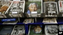 Newspapers with pictures of Nelson Mandela on the front page on sale in London, Dec. 6, 2013. 