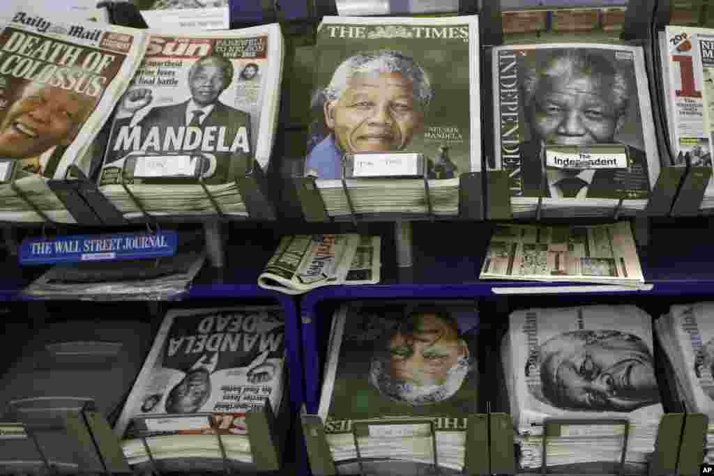 Newspapers with pictures of Nelson Mandela on the front page on sale in London, Dec. 6, 2013. 