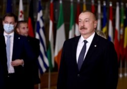 FILE - Azerbaijan's President Ilham Aliyev (R) stands during the Eastern Partnership summit in Brussels on Dec. 15, 2021.