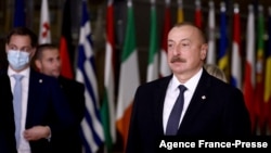 FILE — Azerbaijani President Ilham Aliyev, right, stands in Brussels on Dec. 15, 2021. Azerbaijan is set to hold snap presidential elections on Wednesday, with seven candidates vying for the top position; Aliyev is expected to secure victory.