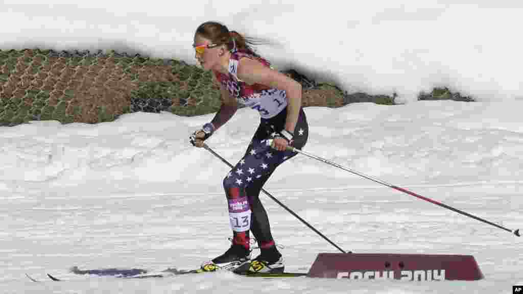 United States' Sophie Caldwell skis with a sleeveless top as temperatures went well over the freezing point during the women's 10K classical-style cross-country race at the 2014 Winter Olympics, Feb. 13, 2014.
