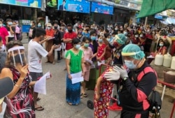 People stand in lines to get COVID-19 tests in Samut Sakhon, South of Bangkok, Thailand, Sunday, Dec. 20, 2020. (AP Photo)
