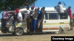 Some touts hanging on kombi windows in Chitungwiza on Tuesday following clashes between the police and kombi drivers. (Photo: Councillor Rangarirai Mutingwende)