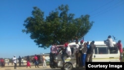 Some touts hanging on kombi windows in Chitungwiza on Tuesday following clashes between the police and kombi drivers. (Photo: Councillor Mutingwende)