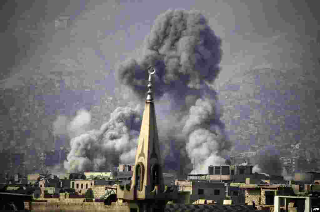 Smoke rises following a reported airstrike on the rebel-held besieged town of Arbin, in the Eastern Ghouta region on the outskirts of Damascus, Syria.