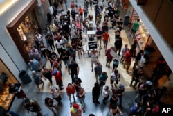 FILE - Protesters march through West County Mall in Des Peres, Missouri, Sept. 16, 2017.