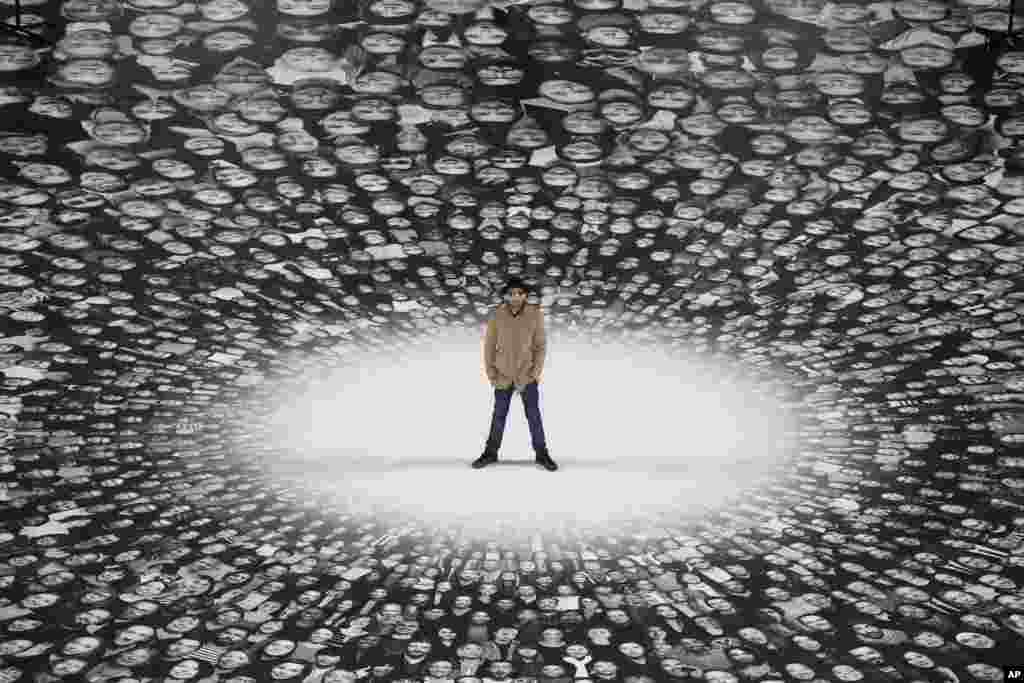 French street artist and photographer JR poses on his creation during the presentation to the press at the Pantheon in Paris. French Government named JR to decorate with portraits of Paris&#39; Pantheon, that is the final resting place for 72 of France&#39;s renowned men, and just one woman, as the monument is undergoing a 2 year renovation.