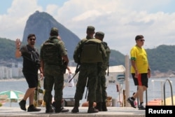 Brazilian Navy soldiers patrol the Copacabana beach near the place where Brazil's President-elect Jair Bolsonaro and Israeli Prime Minister Benjamin Netanyahu attend a lunch in Rio de Janeiro, Dec. 28, 2018.