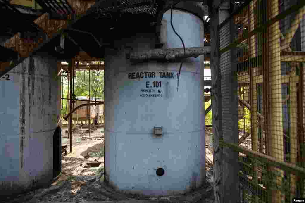 A reactor tank stands among the ruins of the abandoned former Union Carbide pesticide plant in Bhopal, Nov. 14, 2014. On the night of December 2, 1984, the factory owned by the U.S. multinational Union Carbide Corporation accidentally leaked cyanide gas into the air, killing thousands of largely poor Indians in the central city of Bhopal.