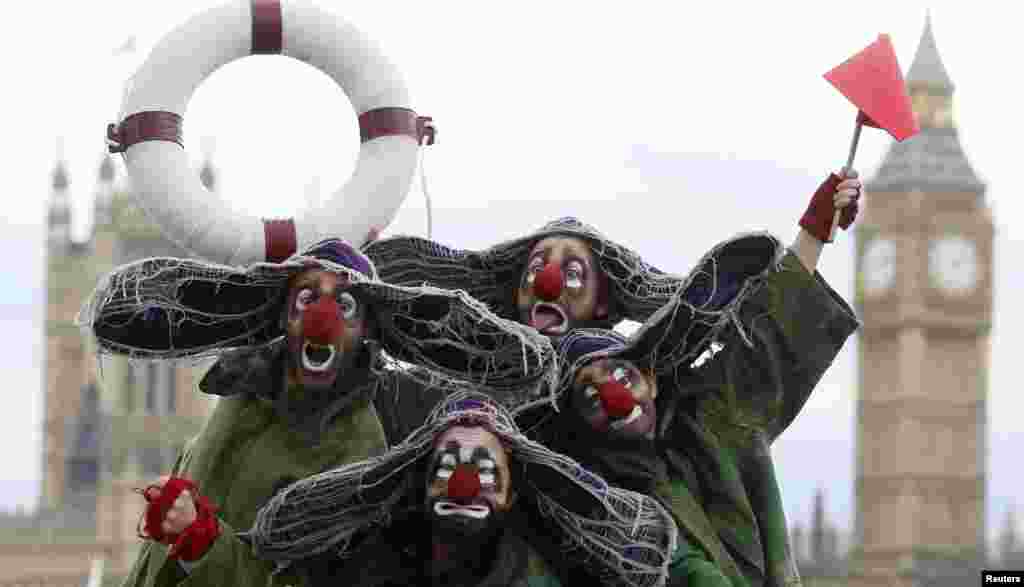 Clowns from Slava's Snowshow pose for photographers on London's South Bank.