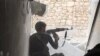FILE - An Islamic State fighter in Kobani, Syria. 