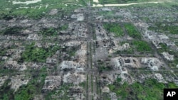 Residential buildings razed to the ground and shell craters are seen in an aerial view of Maryinka, an eastern city where the heaviest battles with the Russian troops have been taking place in the Donetsk region, Ukraine, May 11, 2023.