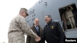 U.S. Defense Secretary Leon Panetta (R) shakes hands with Marine General John R. Allen (L), commander of International Security Assistance Force, upon Panetta's arrival at International Airport, December 12, 2012. 