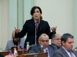 FILE - Assemblywoman Lorena Gonzalez, D-San Diego, urges lawmakers to approve her measure to give new wage and benefit protections at the so-called gig economy companies like Uber and Lyft, during the Assembly session in Sacramento, Sept. 11, 2019.