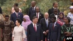 China's President Xi Jinping (C) and his wife Peng Liyuan get ready to pose for a group photograph with leaders from African nations ahead of a dinner reception during the Forum on China-Africa Cooperation (FOCAC) at the Great Hall of the People in Beijin