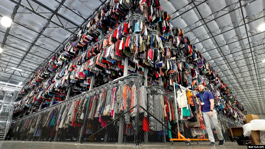 Thousands of clotthes are stored on a three-level system at the ThredUp sorting center in Phoenix on March 12, 2019. (AP Photo/Matt York, File)