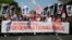 People walk with posters reading: 'Elect a Europe for all' and 'Your choice - May 26.' behind a banner reading: 'A Europe for all; against nationalism,' as they attend a demonstration in Berlin, Germany, May 19, 2019.