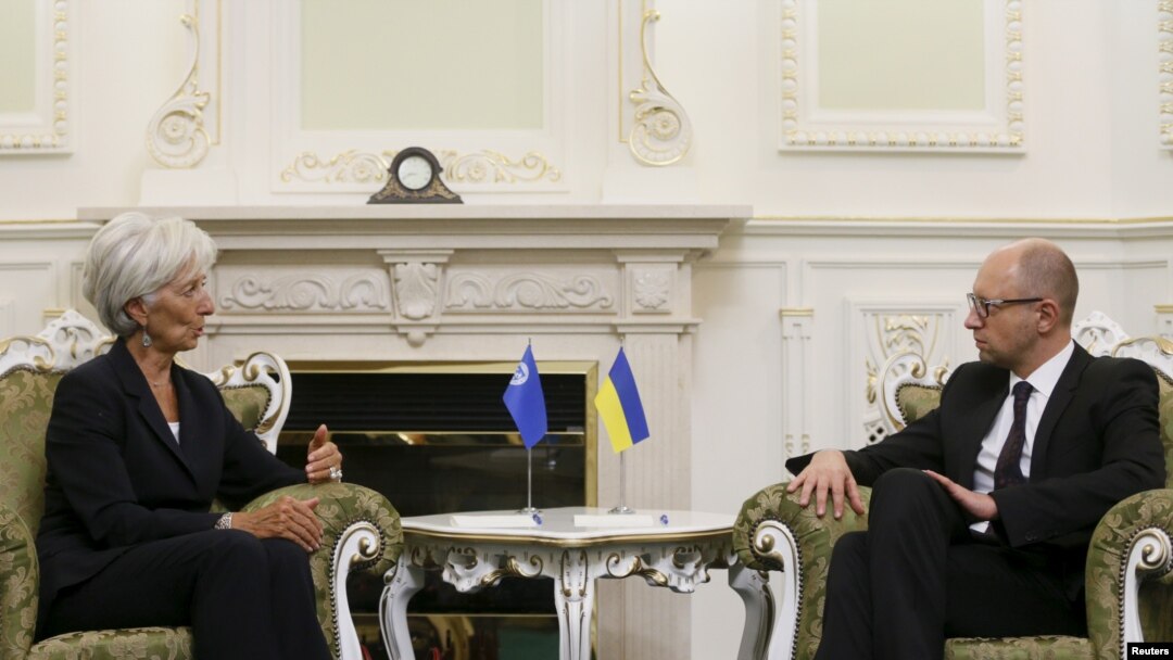 FILE - International Monetary Fund (IMF) Managing Director Christine Lagarde speaks with Ukraine's Prime Minister Arseny Yatseniuk during their meeting in Kiyv, Ukraine, Sept. 6, 2015.