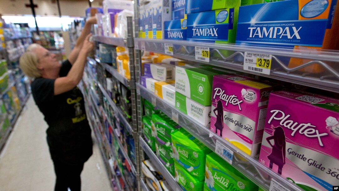 In this June 22, 2016 file photo, Tammy Compton restocks tampons at Compton's Market, in Sacramento, Calif.