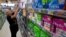 In this June 22, 2016 file photo, Tammy Compton restocks tampons at Compton's Market, in Sacramento, Calif.