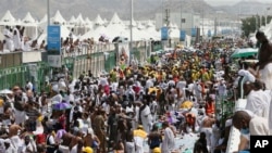 Muslim pilgrims and rescuers gather around the victims of a stampede in Mina, Saudi Arabia, during the annual hajj pilgrimage, Sept. 24, 2015.