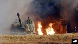 Photo released by S. Korean Ministry of National Defense showing K-9 155mm self-propelled artillery being fired on 23 Nov. into North Korea from Yeonpyeong island