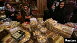 Iranian customers buy sweets and nuts in at a shop for the Yalda feast, an all-night celebrations of the longest night of the year, in Tehran, Iran, Dec. 21, 2011. This year 230 young men and women were arrested at two parties where alcohol was being served.