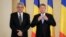 FILE - Romanian President Klaus Iohannis (right) poses with Romanian Prime Minister Mihai Tudose at the Cotroceni Presidential Palace, Bucharest, Romania, June 29, 2017.
