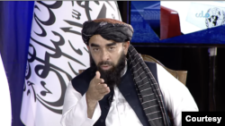 Taliban spokesperson Zabihullah Mujahid speaking on state-run Afghan broadcaster. (VOA screen shot)