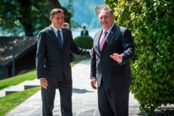 Slovenia's President Borut Pahor, left, welcomes U.S. Secretary of State Mike Pompeo upon his arrival prior to their meeting in Bled, Aug. 13, 2020.