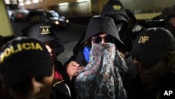 Former first lady and former presidential candidate Sandra Torres is escorted by police to the Supreme Court in Guatemala City, Sept. 2, 2019.