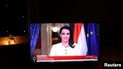 A screen shows Hungarian President Katalin Novak as she announces her resignation on Feb. 10, 2024, after granting a pardon in a sex abuse case, in Budapest.