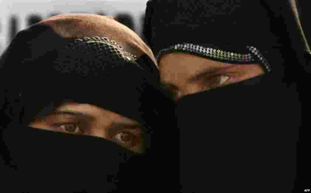 Relatives of a disappeared person whisper as they participate in a protest organized by Association of Parents of Disappeared Persons (APDP), in Srinagar, India, Wednesday, Nov.10, 2010. According to APDP, more than 10,000 people have disappeared in the K