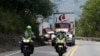 Two semi-trailer trucks containing humanitarian aid from the U.S for Venezuela are escorted by Colombian police in Los Patios, near Cucuta, Colombia, Feb. 7, 2019, about 18 miles from the Colombian-Venezuelan border. 