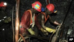 FILE - Gold miners are photographed on Feb. 20, 2014, at South Deep gold mine south of Johannesburg. A report by auditing firm PwC in October 2023 said South Africa may have less than 30 years of a viability left without renewed investment. 